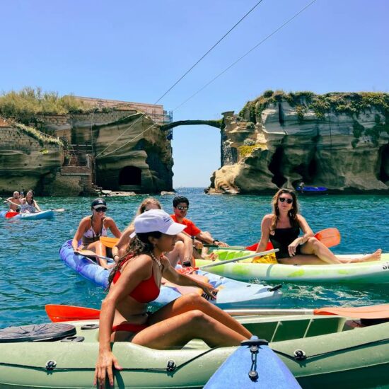 excursionists in kayak paddling in Parco Sommerso di Gaiola