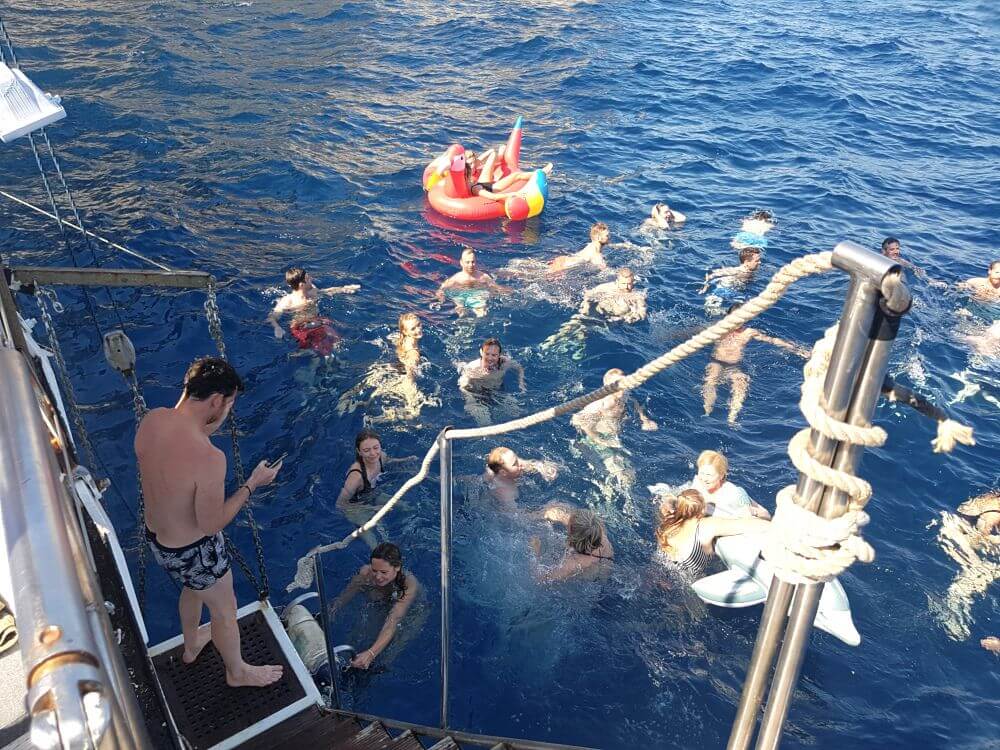 People having fun and bathing in luxury yacht ship