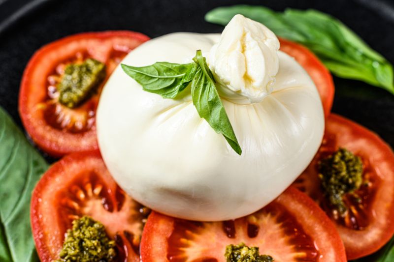 Fresh Buffalo Mozzarella di Bufala served with ripe tomatoes and basil