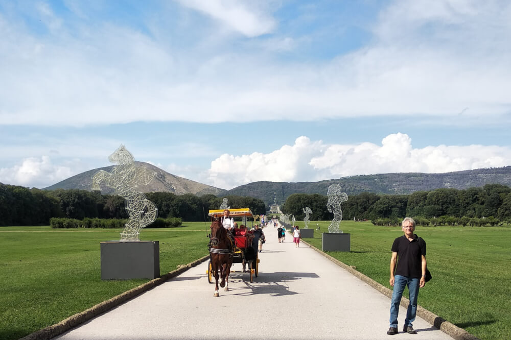 Horse carriage parked in front of the Royal Palace of Caserta facade